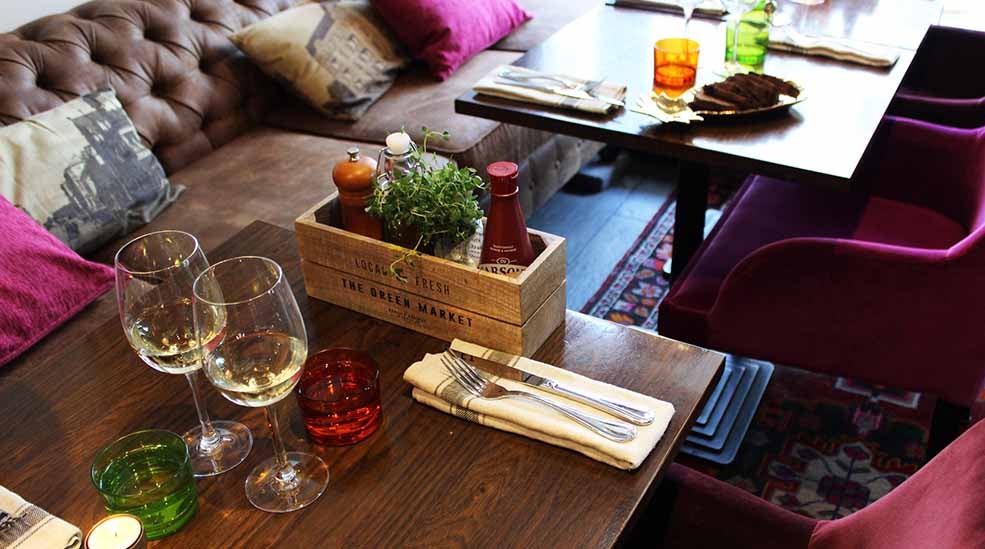 Wine glass, sofa and armchair in the restaurant at the Clarion Collection Hotel Drott