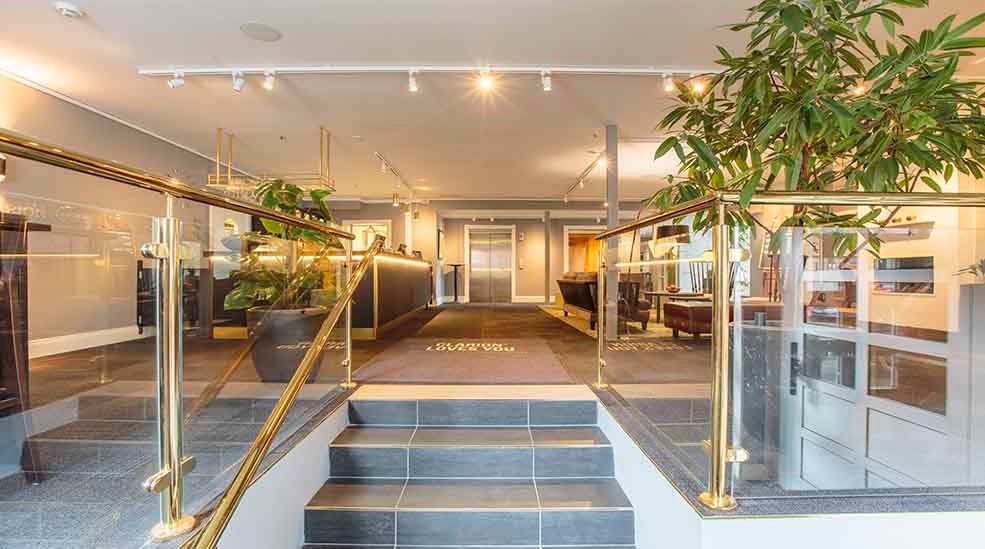 Lobby entrance with green flowers at Clarion Collection Hotel Uman Umeå