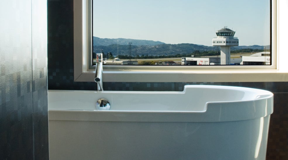 Enjoy the view of the airport from the bathtub in the suite at Bergen Airport Hotel in Bergen