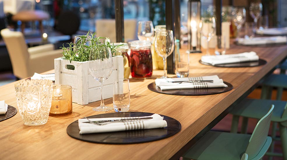 Restaurant interior design characterised by a traditional Swedish long table at Hotel Orebro