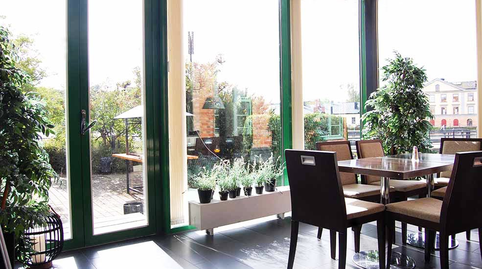 Dining room with chairs and overview of the courtyard at the Clarion Collection Hotel Bolinder Munktell Eskilstuna